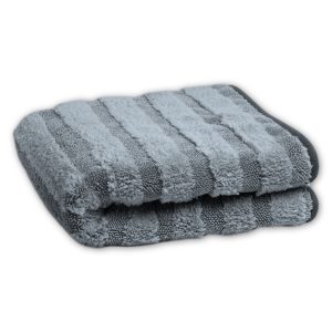 Folded light grey microfiber towel in stripes of long soft high pile and lower twisted loop stripes and with smooth grey edging.