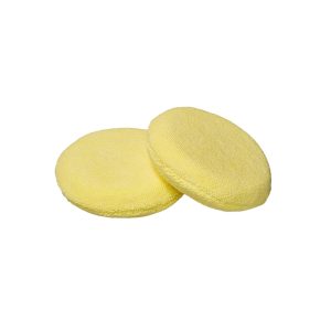 Two circular yellow hand applicator pads for waxing in microfiber material.