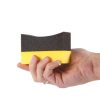 Black and yellow foam curved applicator for tyres being grasped by a hand.