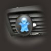 Liquid membrane light blue doll shaped air freshener stuck to vent of car.