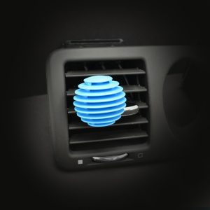 Grooved sphere shaped 3D air freshener in light blue colour, stuck to vent of car.