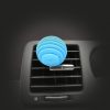 Grooved sphere shaped 3D air freshener in light blue colour, stuck to vent of car at an angle.