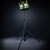 Two work lights on black tripod with stand.