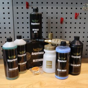 Blizzard snow foam lance by Angelwax standing beside an assortment of Angelwax products that it can be used with.