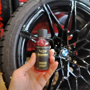 Small glass bottle containing Enigma Legacy titanium ceramic coating for wheel and caliper.