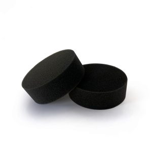 Two black thick foam applicator pads leaning against each other.