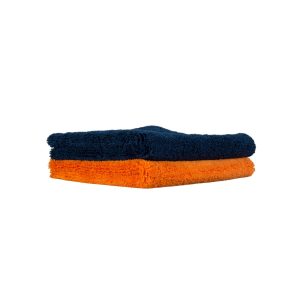 Thick dark blue microfiber buffing towel sits folded over another one in orange colour.