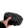 Black finishing double sided waffle foam pad with a five eighths fitting being held by a hand.