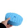 Blue medium cut double sided waffle foam pad with a five eighths fitting being held by a hand.