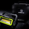 Work light by Unilite with handle and with black case behind it.